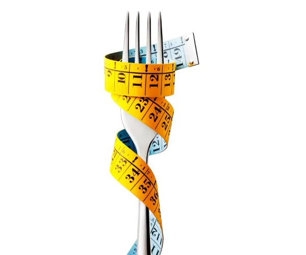 Image of a fork with tape measure wrapped around it in a spiral.