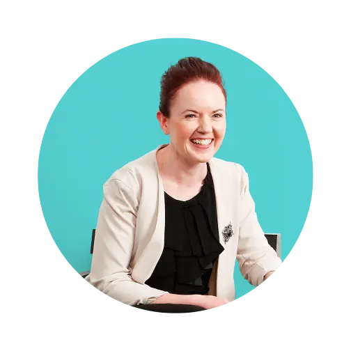 Image of a smiling woman sitting in black chair.